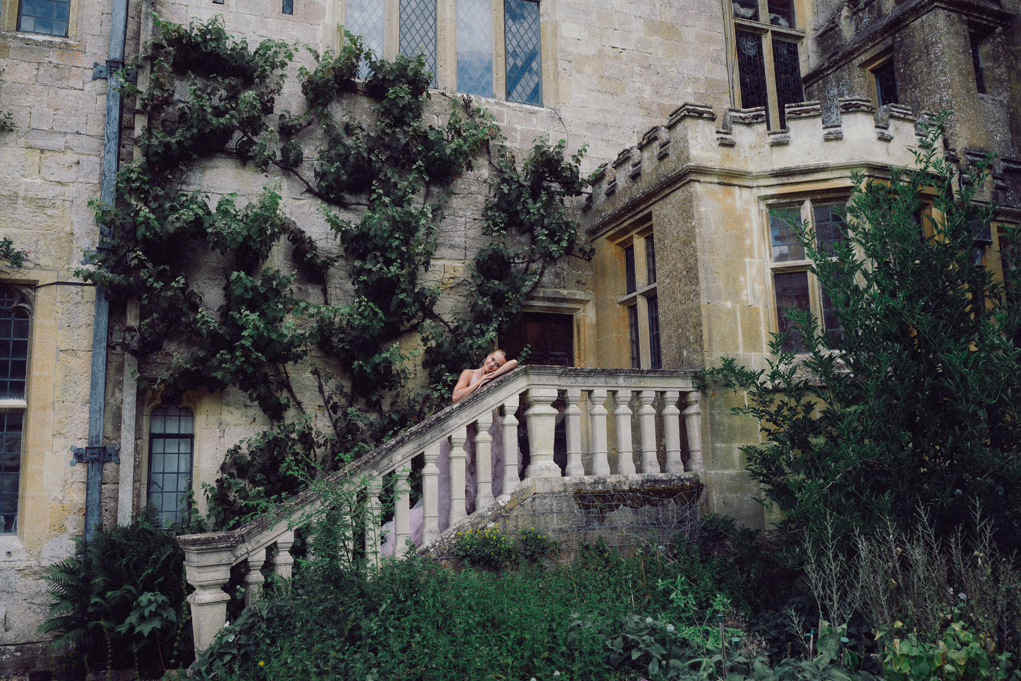 Exterior of Sudeley Castle with historic stone architecture and gardens, photographed in soft natural light.