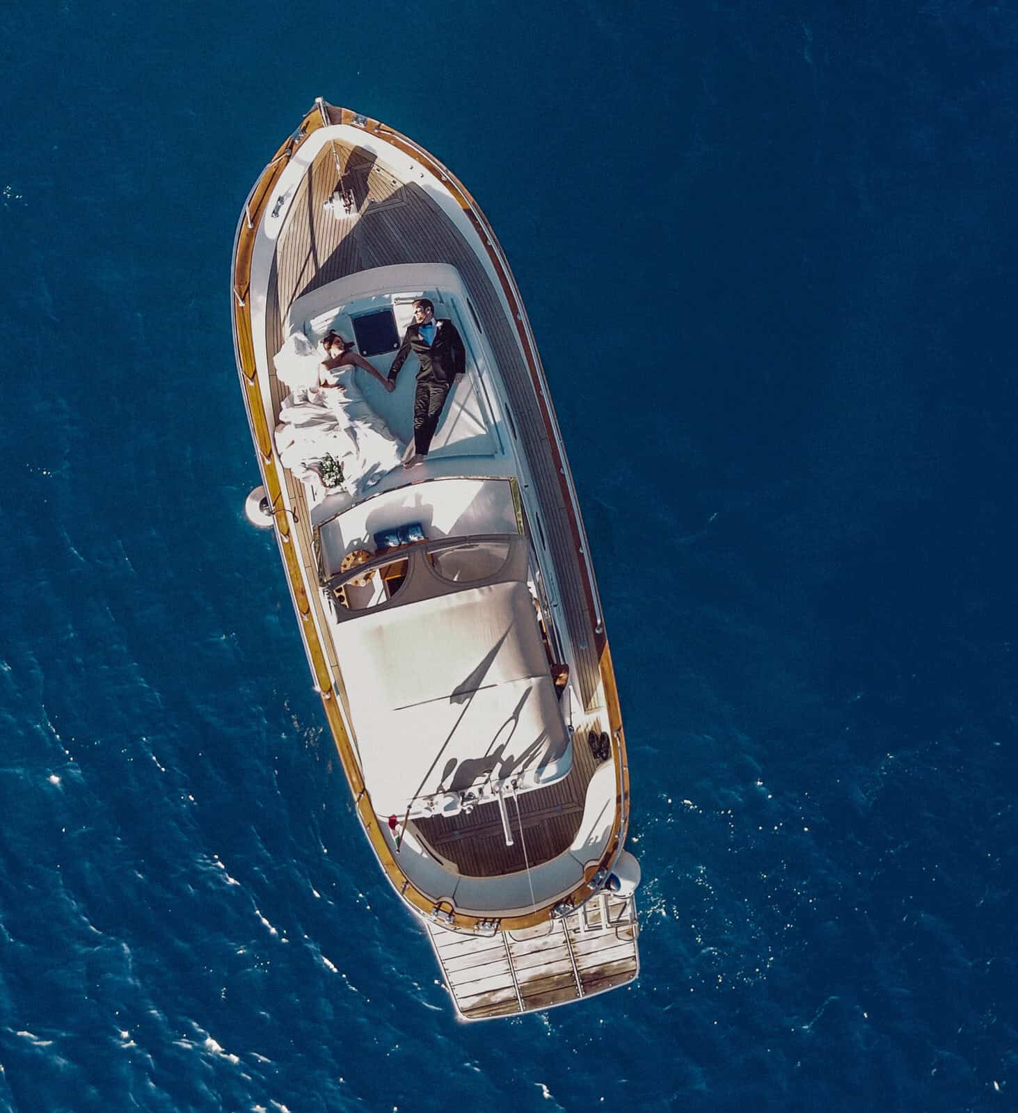 Elegant yacht cruising in blue waters for destination wedding photography in Italy.
