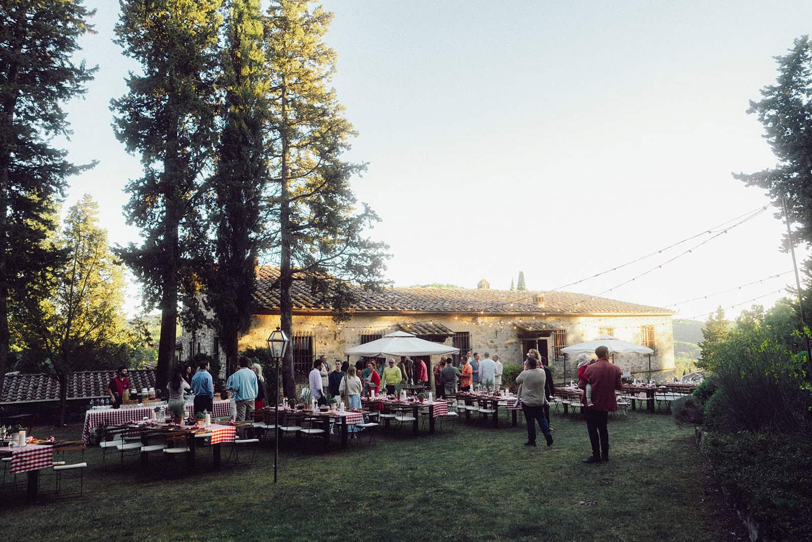 Guests gathering for an outdoor welcome dinner at a Tuscany wedding venue in Italy